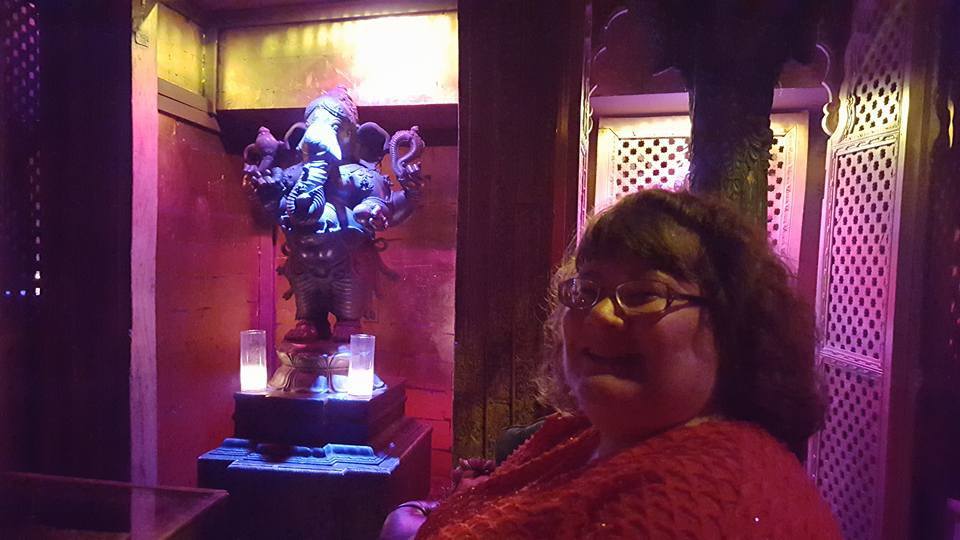 Ganesha is seen here photobombing a picture of my wife in our private dining area.